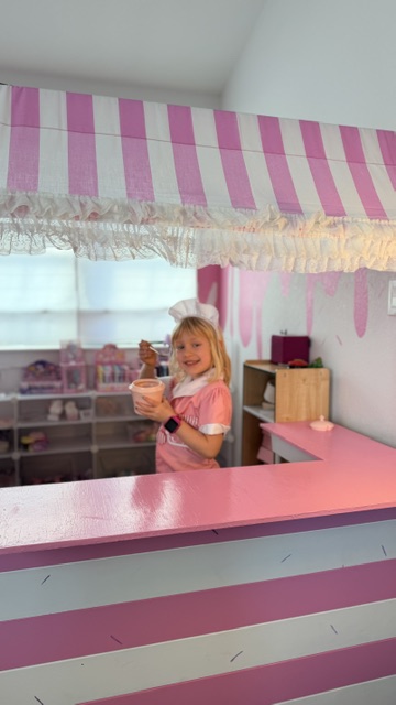 Ellie holding a fresh scoop of strawberry ice cream