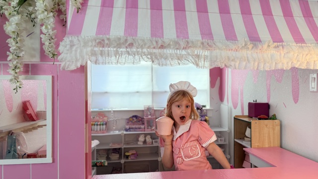 Ellie behind the counter of her pink scoop shop